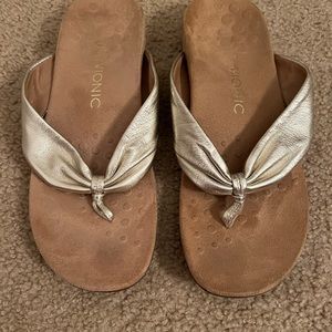 Vionic gold flip flops, size 10